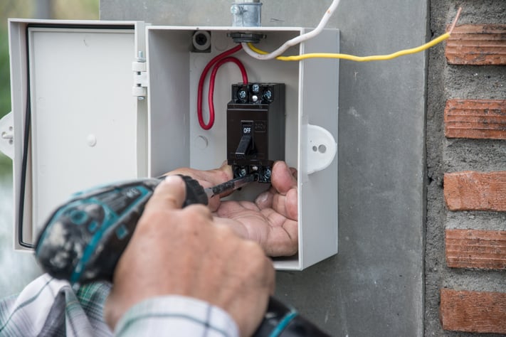 installing electric system on wall in construction site shutterstock_672319048